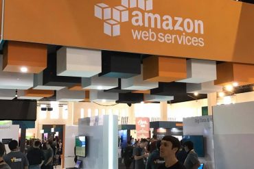 amazon web services sign over an open-plan office