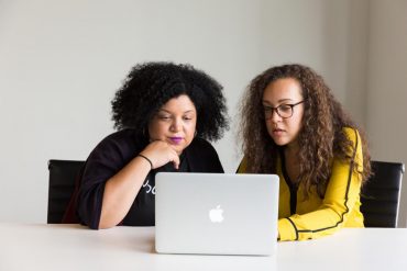 Two Black women using a laptop together