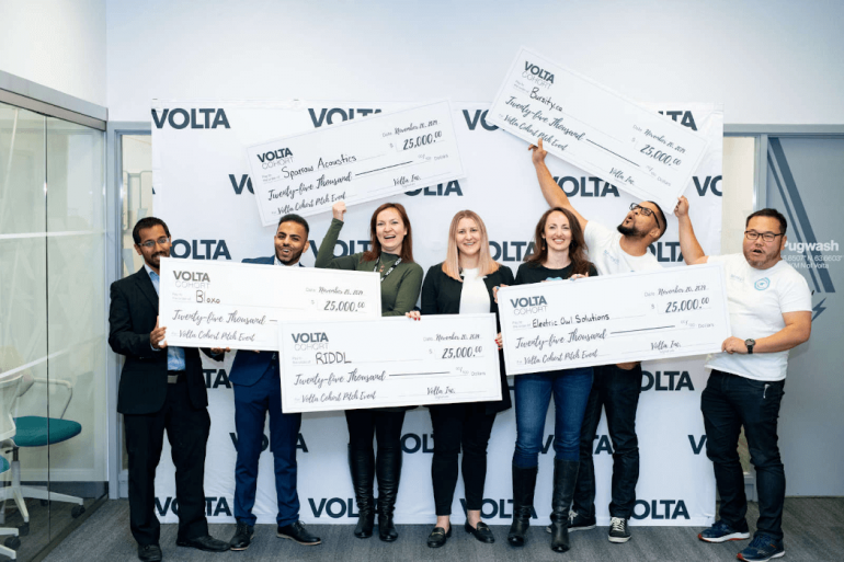 Volta pitch competition winners holding big $25000 cheques