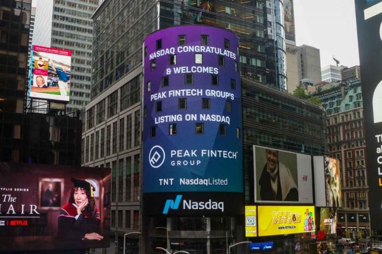 A billboard congratulating Peak Fintech Group on being listed on NASDAQ