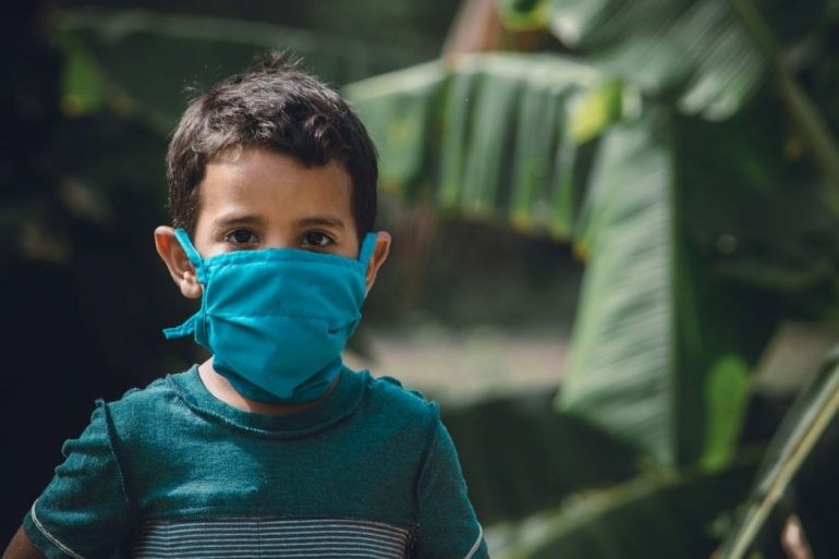 A child wearing a blue face mask