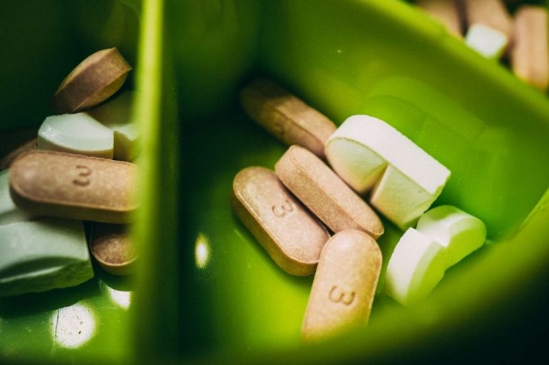 Prescriptive drugs in a green container