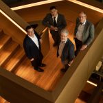 the evolution Q executive team portrait on a dramatic staircase