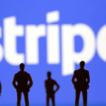 Silouettes of people standing infront of a Stripe logo.