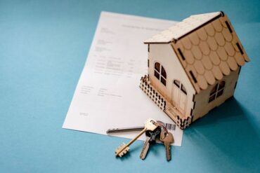 wooden house on top of legal documents.