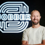 Sam Pillar in front of Jobber logo