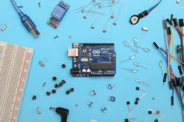 A microchip surrounded by other components and tools.