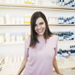 Sampler founder and CEO Marie Chevrier standing in front of product samples her company helps brands distribute.