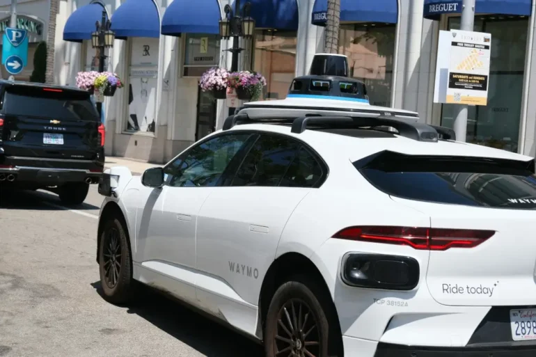 A Waymo car on a busy street